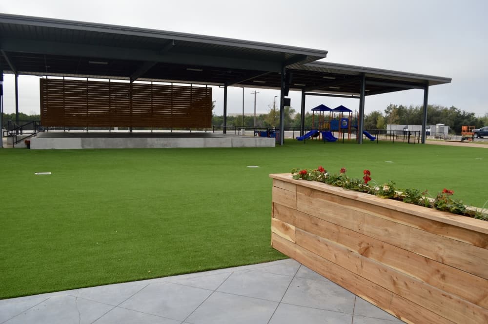 The Fieldhouse has an outdoor entertainment space with a stage for live music. An outdoor TV will be added for guests to watch football and other games. (Taylor Girtman/Community Impact Newspaper)