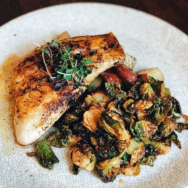 Blackened Snapper ($24): A fillet of snapper is drizzled with lemon beurre blanc sauce and served with Brussels sprouts and roasted potatoes. (Courtesy the Annex Crafthouse)