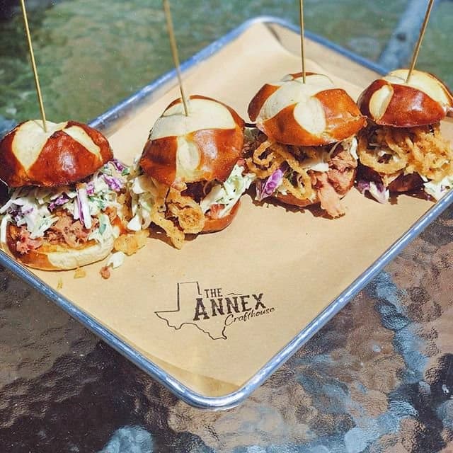 Crafthouse Sliders ($12.75): Four mini pretzel buns are topped with smoked brisket, barbecue sauce, coleslaw and onion strings. (Courtesy the Annex Crafthouse)