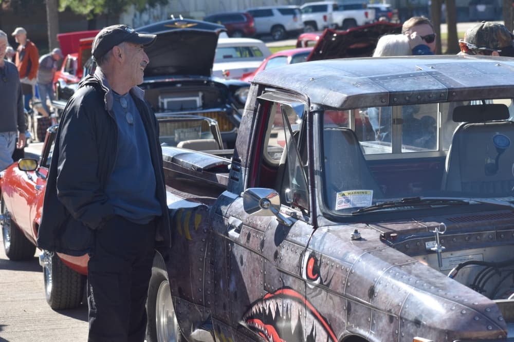 Colleyville Fall Car Show attendees discuss the cars present Nov. 13 at Colleyville City Hall. (Anjali Krishna/Community Impact Newspaper)