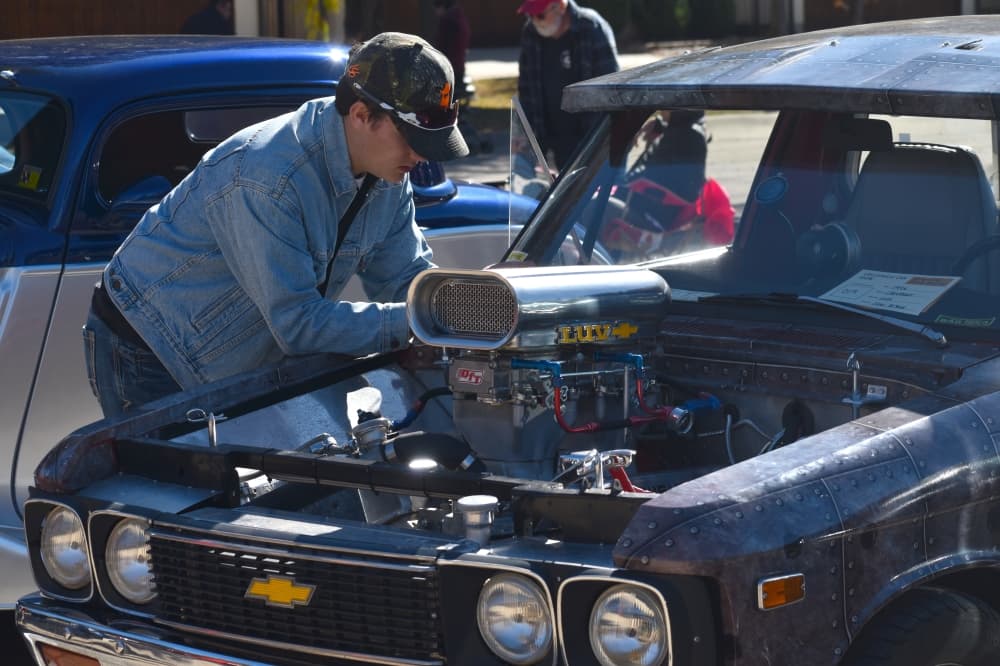 Jake Arbut leans on his 1976 Chevrolet LUV at the Colleyville Fall Car Show on Nov. 13 at Colleyville City Hall. (Anjali Krishna/Community Impact Newspaper)