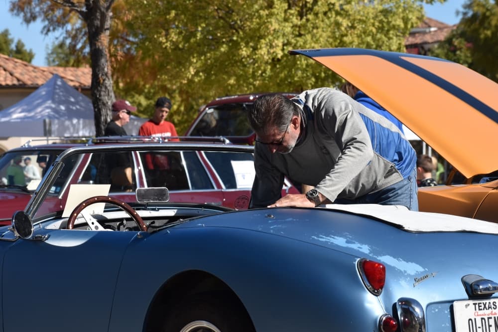 Mark Martin cleans his 1959 Austin-Healey Bugeye Sprite at the Colleyville Fall Car Show on Nov. 13 at Colleyville City Hall. (Anjali Krishna/Community Impact Newspaper)