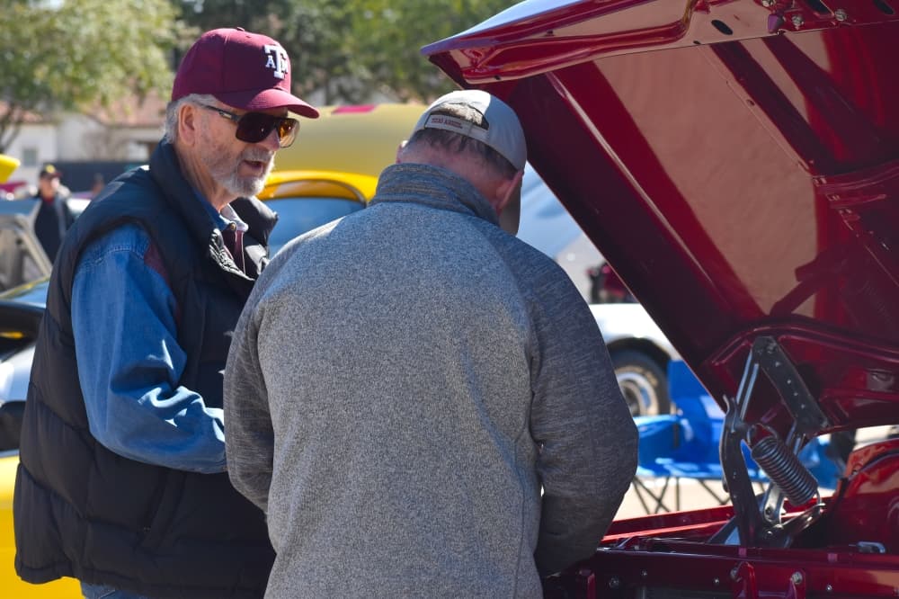 John Martin speaks with a truck owner at the Colleyville Fall Car Show. (Anjali Krishna/Community Impact Newspaper)