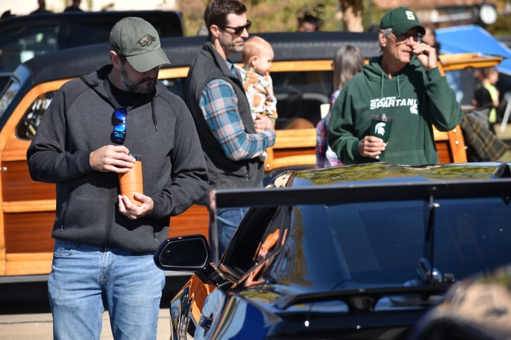 Matt Hopkins inspects a Camaro at the Colleyville Fall Car Show on Nov. 13 at Colleyville City Hall. (Anjali Krishna/Community Impact Newspaper)