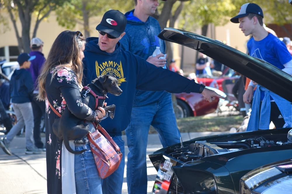 Scott Harlow chats about a 1967 Shelby GT500CR with his wife at the Colleyville Fall Car Show. (Anjali Krishna/Community Impact Newspaper)