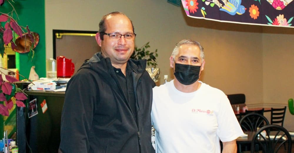 From left: Owners Luis Maldonado and Alejandro Flores stand in front of the bar at Di Maria Fresh Food in Humble. (Wesley Gardner/Community Impact Newspaper)