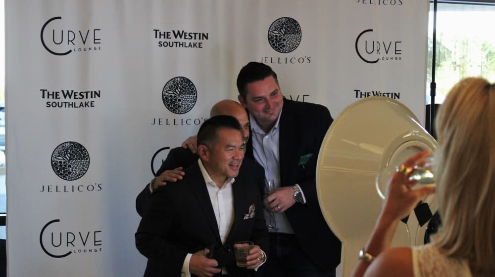 Guests enjoy the interactive photo booth at the ribbon-cutting ceremony. (Sandra Sadek/Community Impact Newspaper)