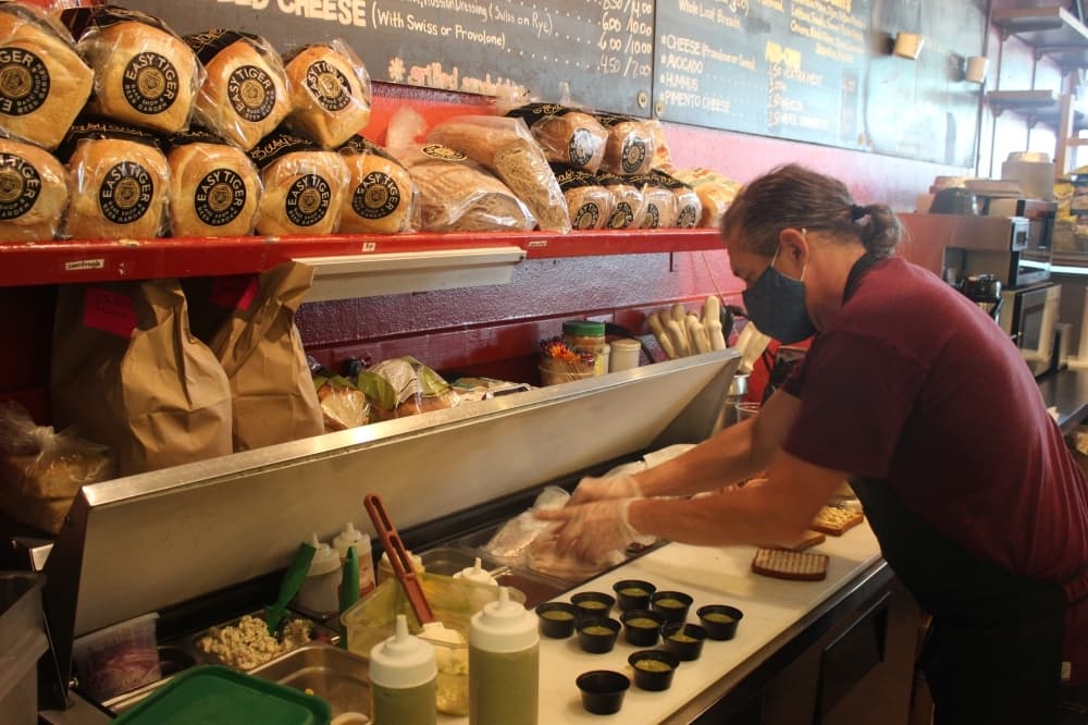 Barkley prepares a sandwich. (Olivia Aldridge/Community Impact Newspaper)