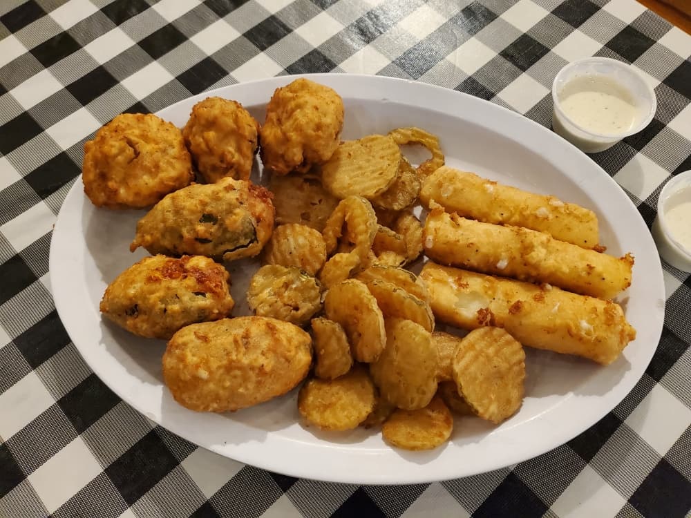 The Appetizer Sampler ($11.99) includes jalapeño bombers, cheese sticks, beer battered mushrooms and fried dill pickles. (Jarrett Whitener/ Community Impact)