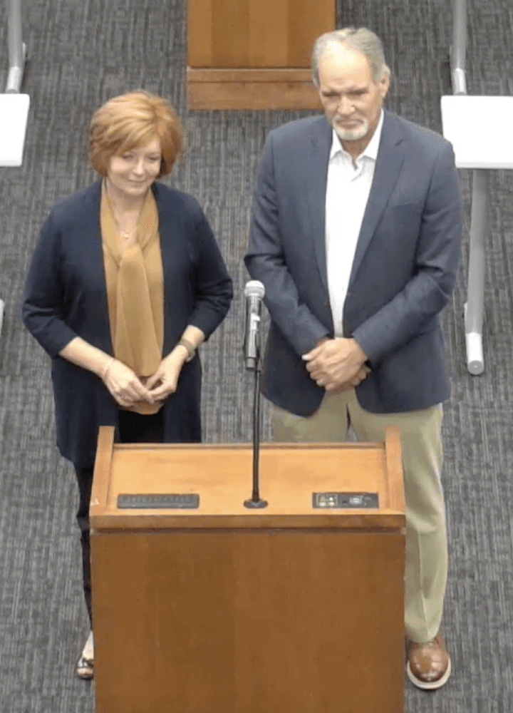 man and woman at podium