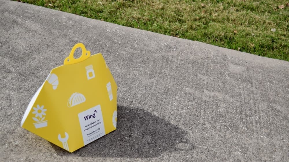 Packages delivered by Wing's drones come in yellow, recyclable totes. (Matt Payne/Community Impact Newspaper)