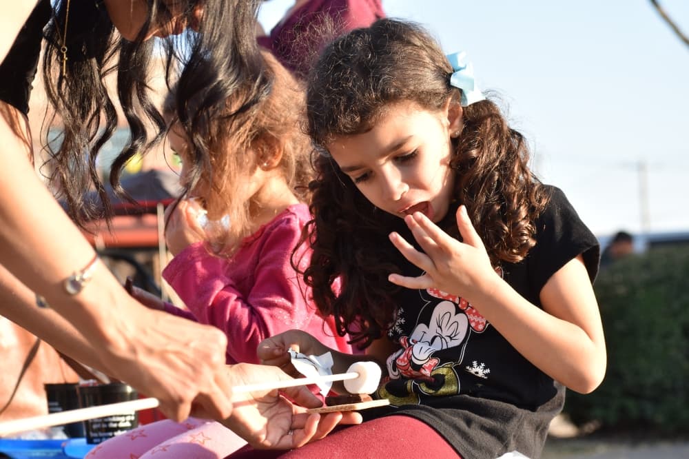 Attendees enjoy s'mores at Roanoke's Hometown Holiday event. (Anjali Krishna/Community Impact)