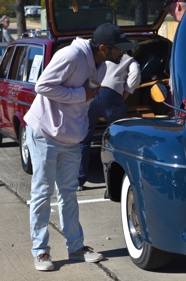 Mason Kuriea inspects a van at the Colleyville Fall Car Show on Nov. 13 at Colleyville City Hall. (Anjali Krishna/Community Impact Newspaper)