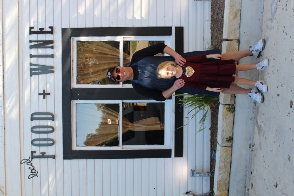Ross Wilkinson and his daughter Lila Grace stand in front of The River House in Gruene. (Eric Weilbacher/Community Impact Newspaper)
