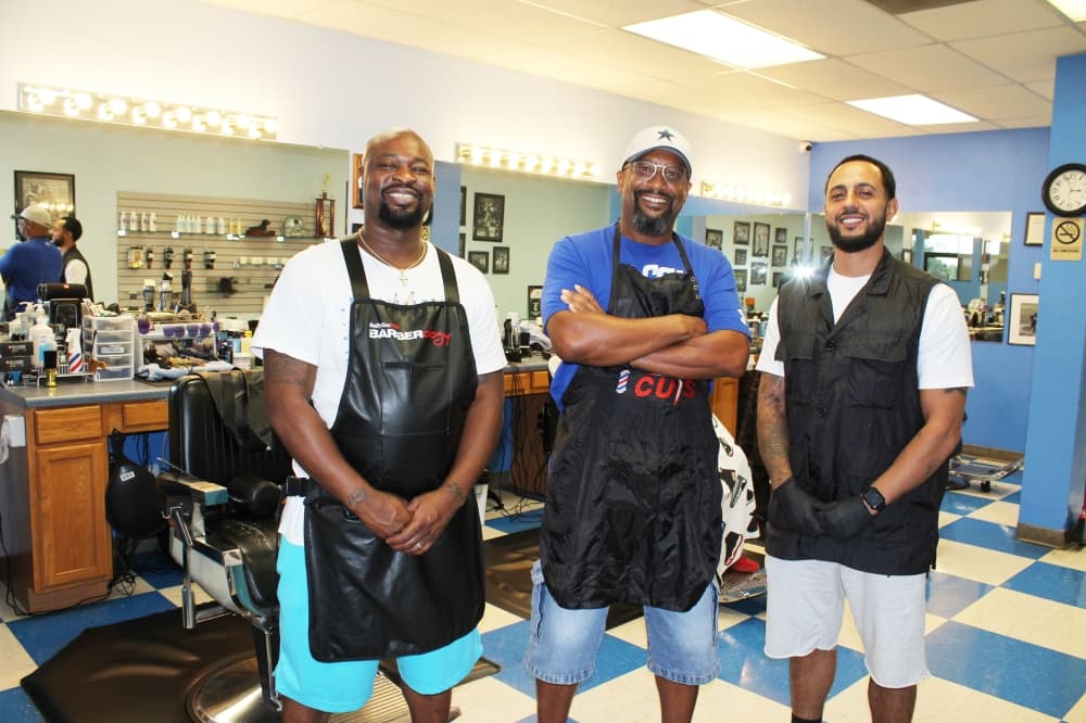 Troy Cuts owner Troy Butler with two employees