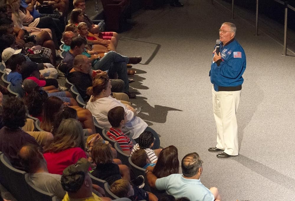 An astronaut addresses a room 
