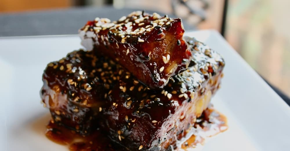 Hong Kong Ribs ($14): A nod to Chinese cuisine, pork ribs are smothered in a sesame-ginger glaze and Chinese 5-Spice. (Emily Lincke/Community Impact Newspaper)