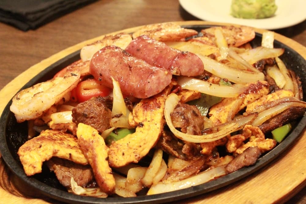 The Parrillada Mix ($15 for one, $29 for two) is a chicken, steak, sausage and shrimp fajita plate. (Sandra Sadek/Community Impact Newspaper)