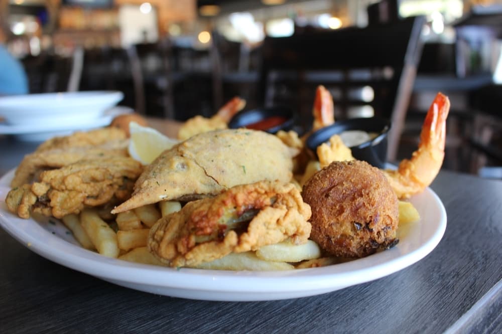 The fried seafood platter ($20.95) consists of fried shrimp, fried stuffed crab, fried fish and hush puppies. (Sierra Rozen/Community Impact Newspaper)