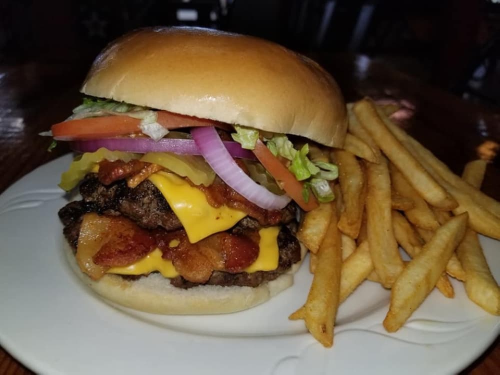 Carls’ signature burger ($11.95) is served with fries. (Jishnu Nair/Community Impact Newspaper)