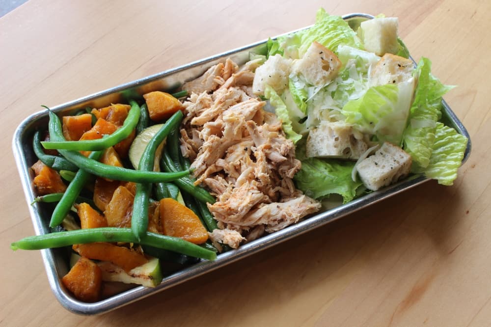 The Lone Star plate ($12.75) offers a protein, such as smoked chicken, and two sides. (Andrew Christman/Community Impact Newspaper)