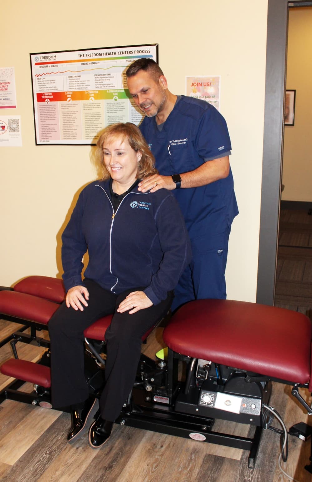 chiropractor todd molski checks a patient's back