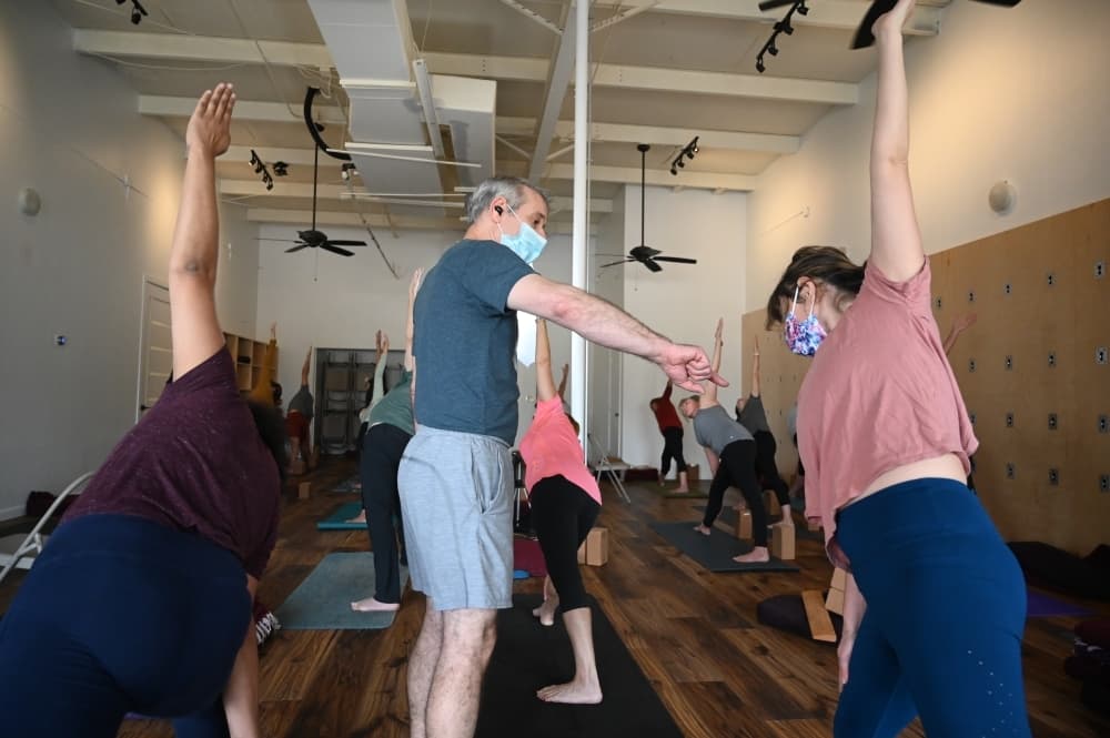 Owner Jonathan Troen offers instruction during a yoga class. (Leila Saidane/Community Impact Newspaper)