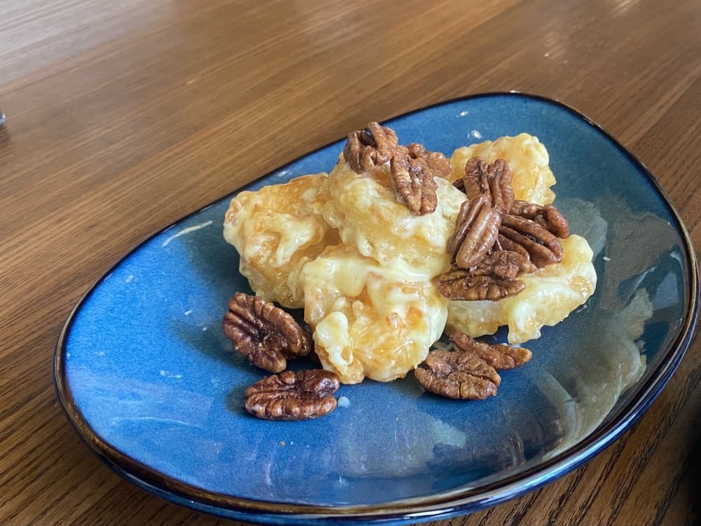 A guest favorite is gulf prawns in lemon aioli, topped with honey-candied local pecans.  (Darcy Sprague/Community Impact Newspaper)
