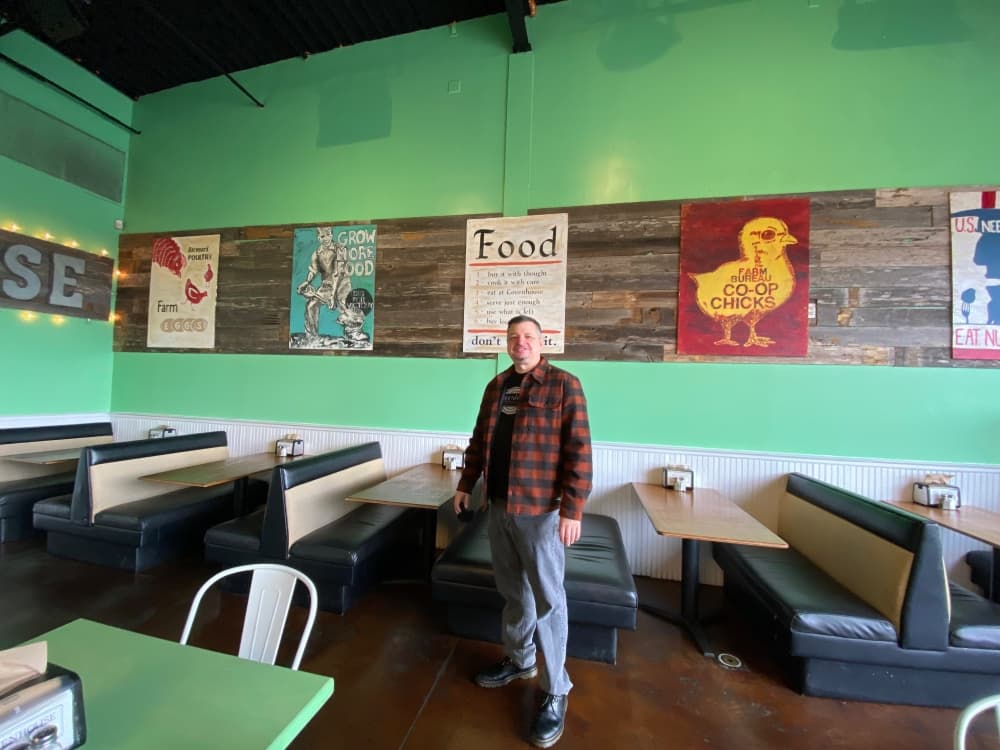Many of the large wooden signs, based on World War II local purchasing campaigns, were hand painted by Rob’s wife Sonja Snow.  (Brooke Sjoberg/Community Impact Newspaper)