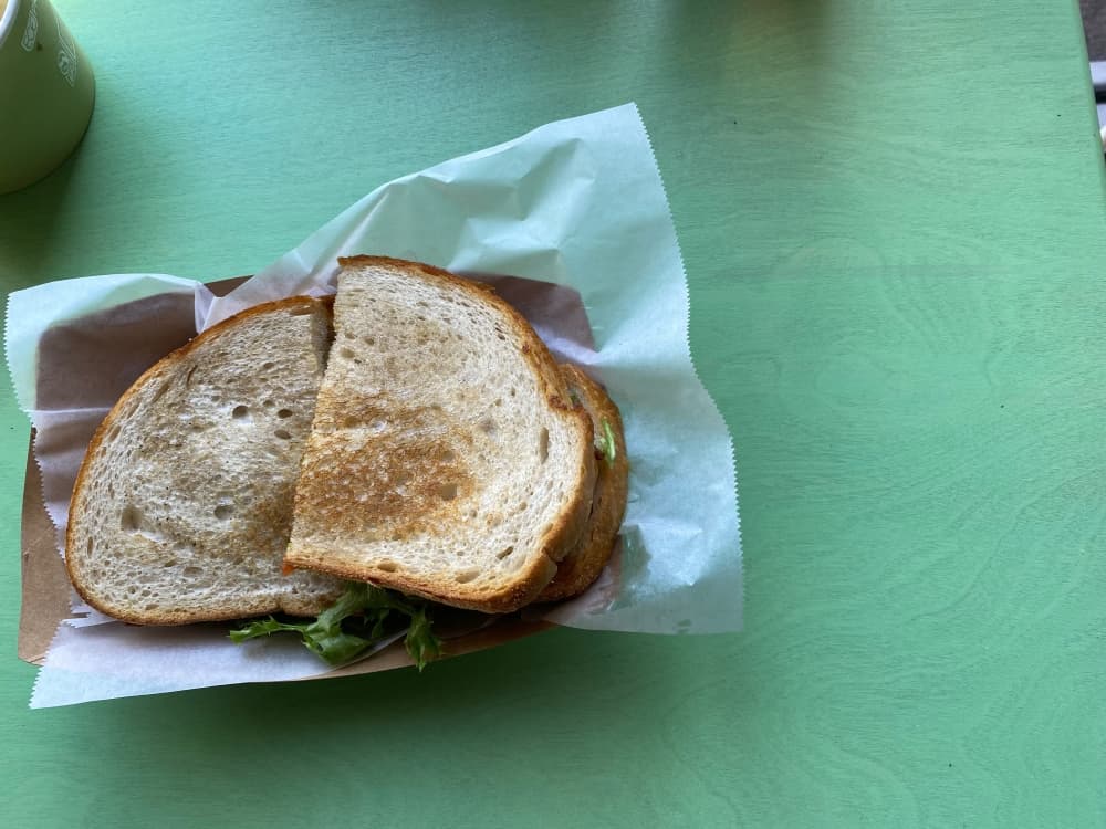 The Greenhouse BLT features classic bacon, greens and tomato as well as a fried egg, mayo and jalapeño maple jelly on sourdough. (Brooke Sjoberg/Community Impact)