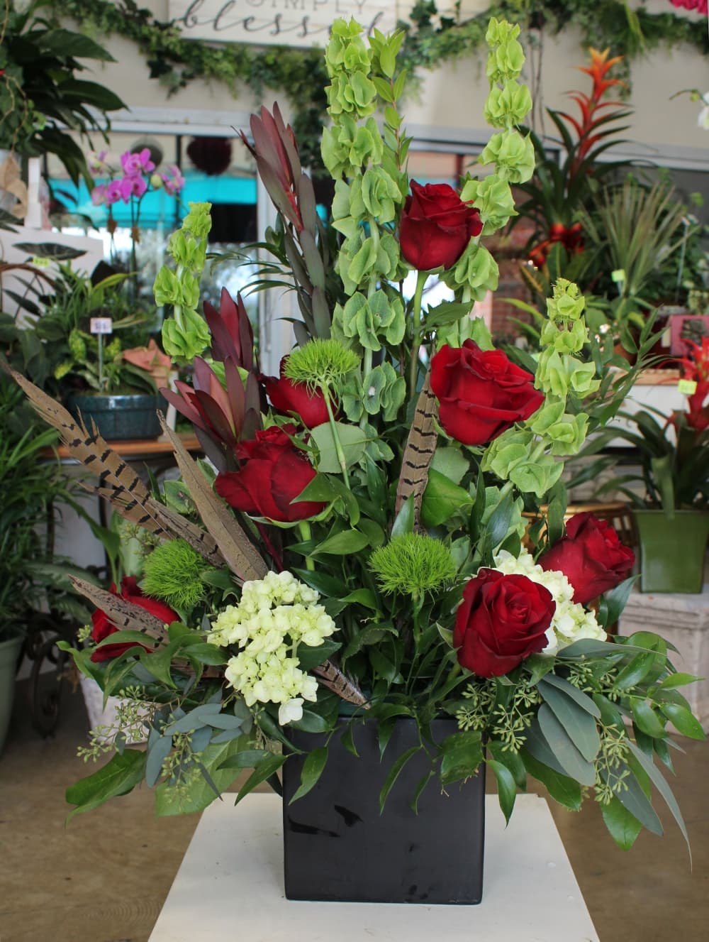 This arrangement includes Bells of Ireland, Explorer roses from Ecuador and pheasant feathers. ($110). (Karen Chaney/Community Impact Newspaper)