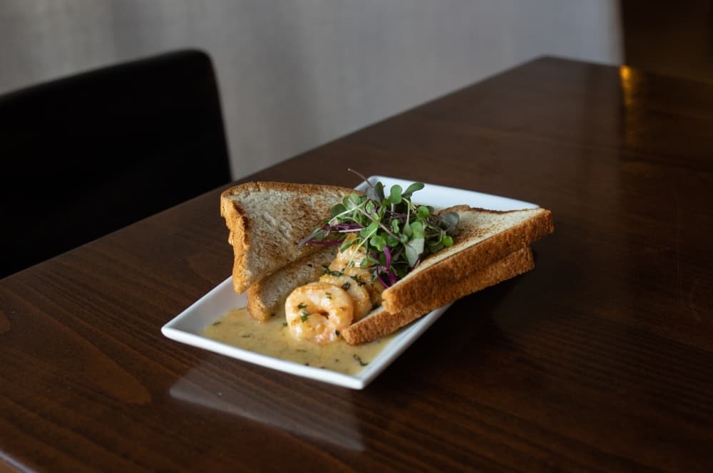 Shrimp Scampi is made with garlic, white whine, lemon and butter, and available with gluten free toast.
