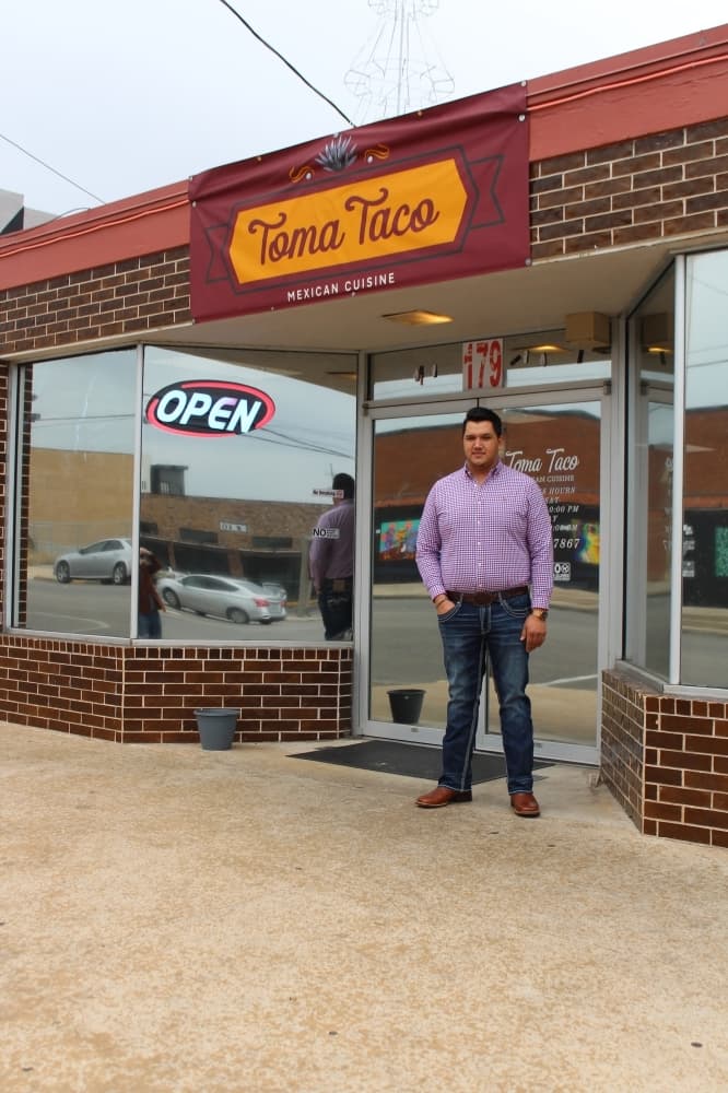 General Manager Oscar Garnica stands in front of Toma Taco in downtown San Marcos.