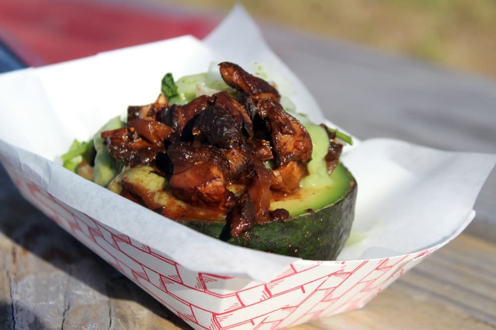 Portobello mushroom pastor stuffed avocado ($6) includes a ripened avocado cut in half and stuffed with portobello mushroom pastor and topped with onions, cilantro and a house made green sauce. (Karen Chaney/Community Impact Newspaper)