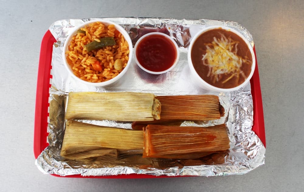 The tamale plate comes with a choice of pork, beef, Hatch chili pork, chicken, habanero pork or black bean tamales (two for $7 or four for $9). It is served with rice and a choice of beans. (Karen Chaney/Community Impact Newspaper)
