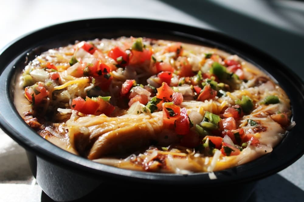 A top seller is the Tommy Bowl with one or two tamales ($7-$9). It comes with rice, queso, Texas beef chili cheese and pico de gallo. (Karen Chaney/Community Impact Newspaper)