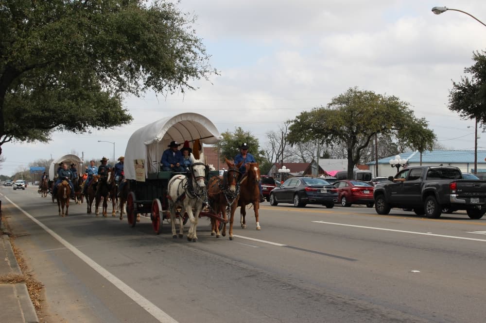 Trail riders paraded along Main Street on Feb. 22 after leaving the Tomball Historic Depot Plaza for an overnight stay at Spring Creek Park. (Kayli Thompson/Community Impact Newspaper)