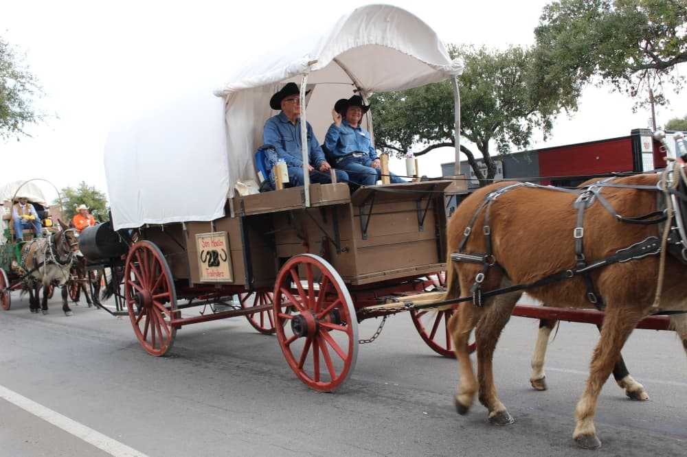 Trail riders paraded along Main Street on Feb. 22 after leaving the Tomball Historic Depot Plaza for an overnight stay at Spring Creek Park. (Kayli Thompson/Community Impact Newspaper)