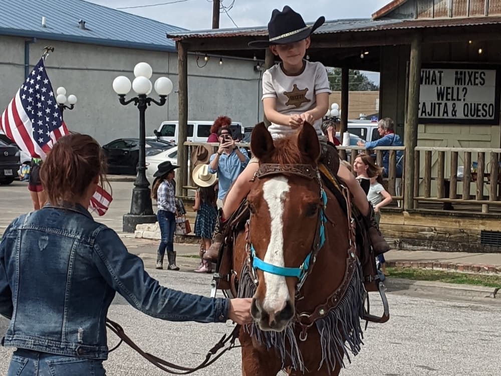 The Tomball community attended a reception for the Sam Houston Trail Riders on Feb. 22 at the Tomball Historic Depot Plaza with food, pony rides and a proclamation issued by city officials in honor of the trail riders. (Anna Lotz/Community Impact Newspaper)