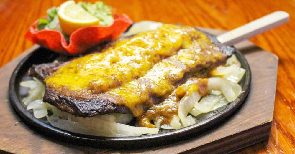 Steak Tampiquena ($16.95): Charcoal-grilled fajita steak is topped with a cheese enchilada. (Wesley Gardner/Community Impact Newspaper)