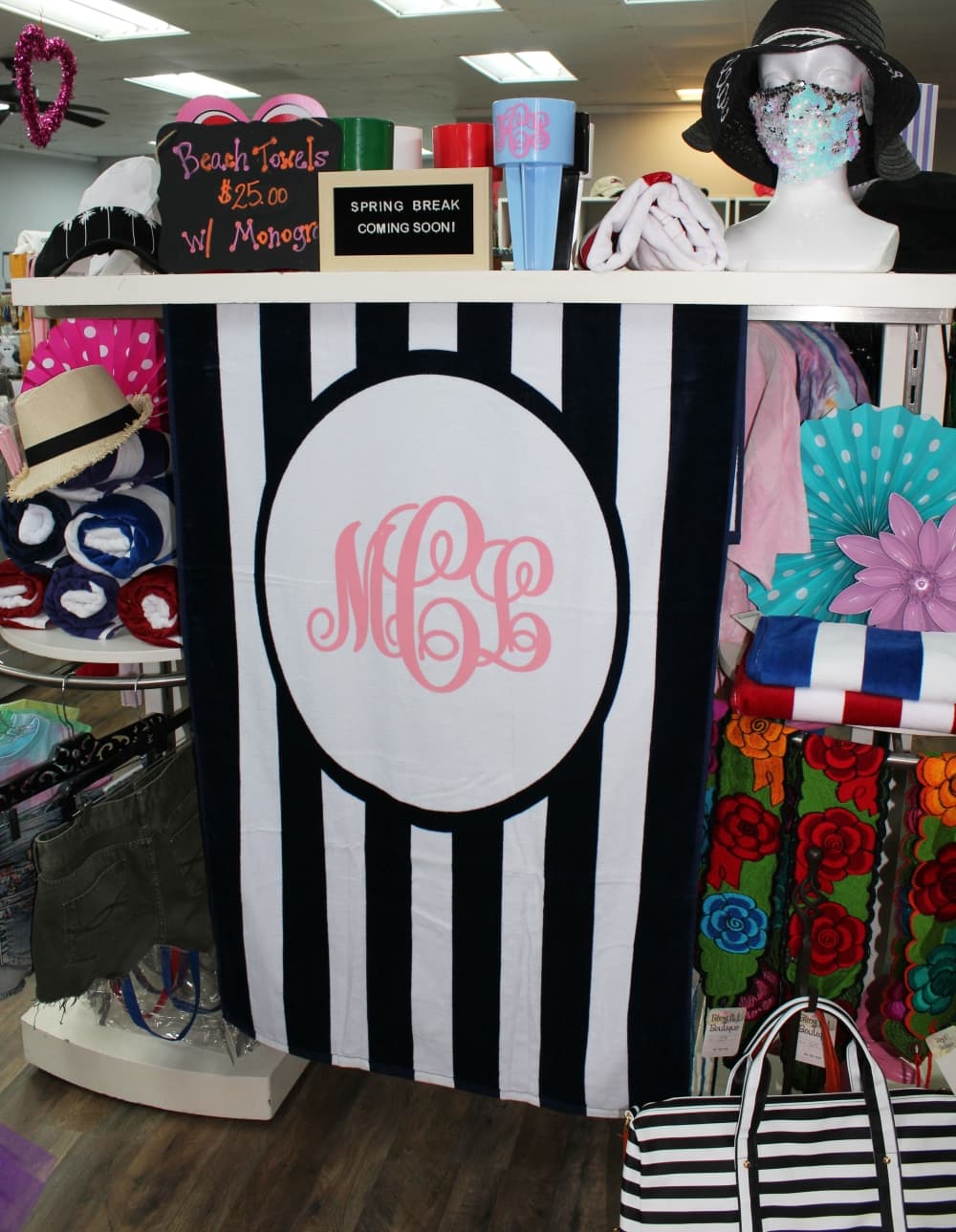 Monogrammed beach towels ($25) are top sellers around spring break, according to co-owner Stacy Correia. (Karen Chaney/Community Impact Newspaper)