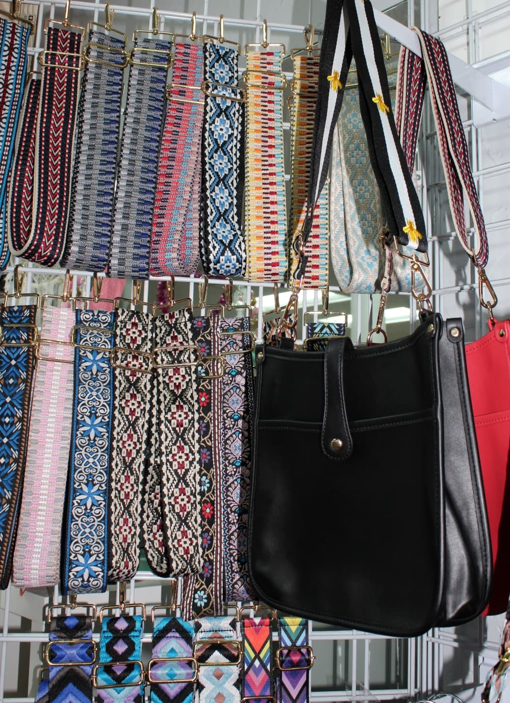 Crossbody purses ($56) with interchangeable straps ($28) are popular, according to co-owner Stacy Correia. (Karen Chaney/Community Impact Newspaper)