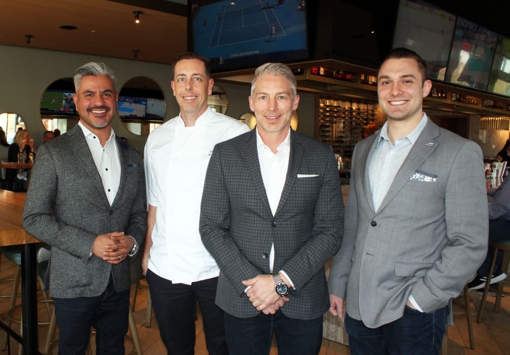 Moxies opened in Southlake in 2020. From left are general manager Ben Madrid, culinary director Steven Chute, president of Eatz Hospitality and Moxies franchisee Paul Randle and operations manager Drew Smith. (Karen Chaney/Community Impact Newspaper)