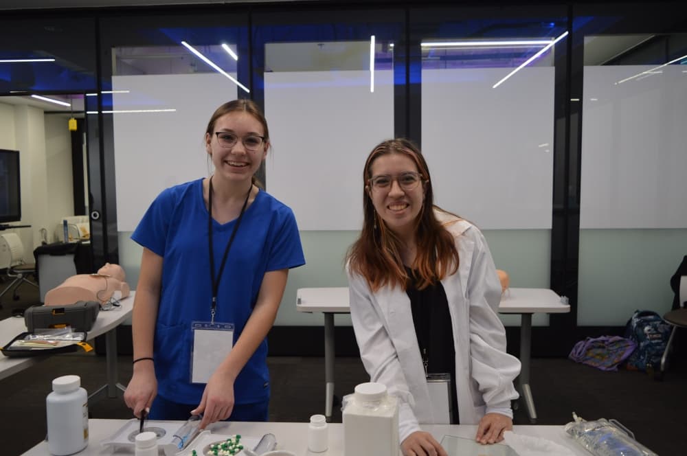 From left: GISD Health Science seniors Emma Tillery and Kendra Gardine demonstrate their pharmaceutical techniques. (Hunter Terrell/Community Impact Newspaper)
