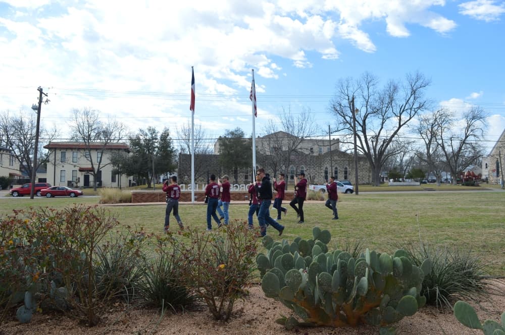 The Georgetown ISD NJROTC marches on the front lawn during the GISD State of the District. (Hunter Terrell/Community Impact Newspaper)