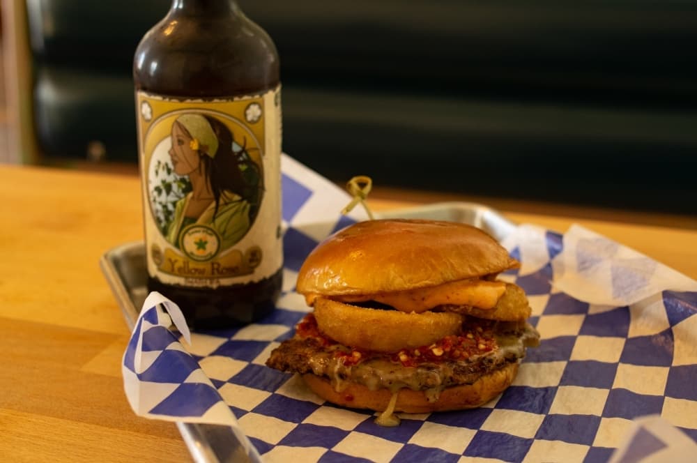 The Double Dog Dare is a hot pepper mash, chipotle mayo, onion rings, pepper jack cheese and a house patty. 