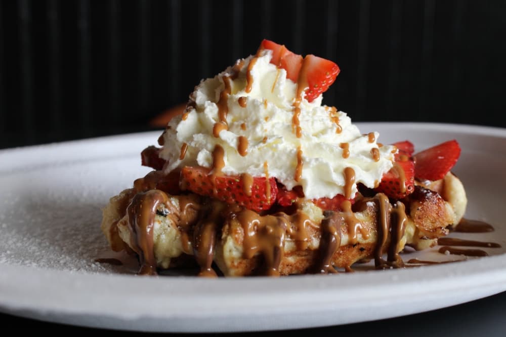 The House ($9.25) is Press Waffle Co.’s specialty waffle, featuring strawberries, Nutella and whipped cream. (Andrew Christman/Community Impact Newspaper)