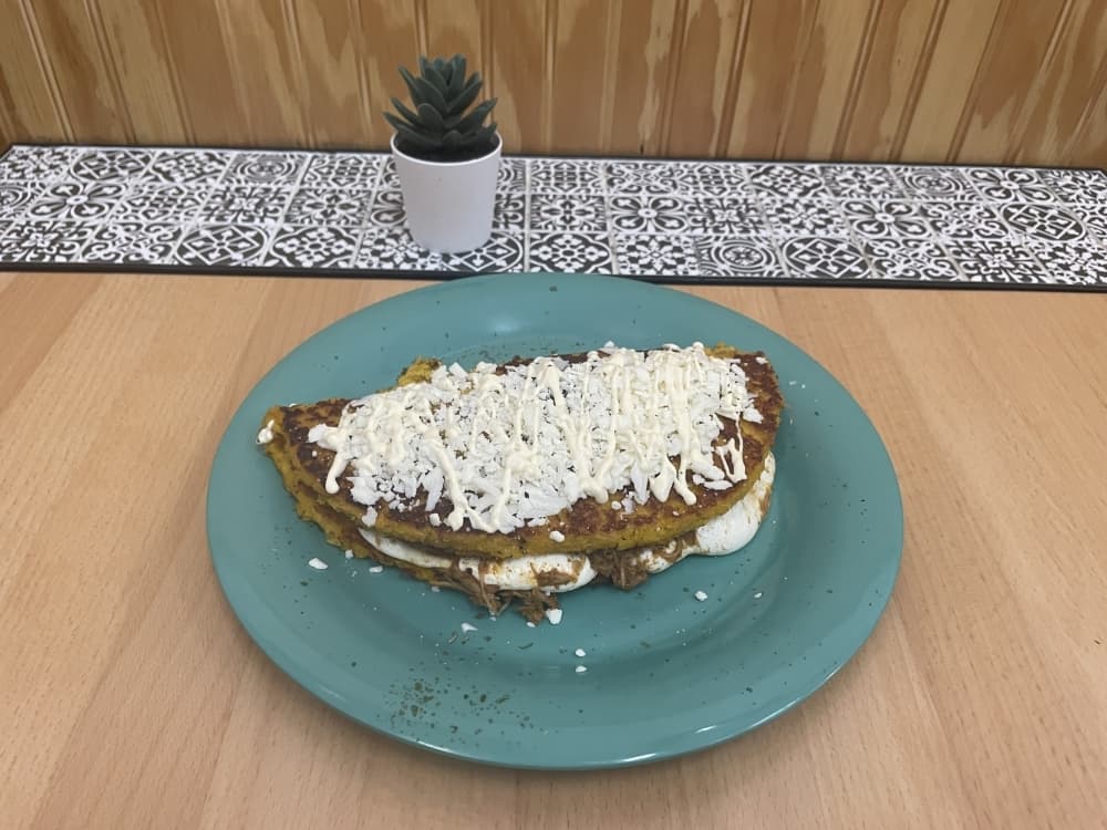 Cachapa Original is served with shredded pork, queso de mano, nata and white cheese ($15.95). (Eddie Harbour/Community Impact Newspaper)