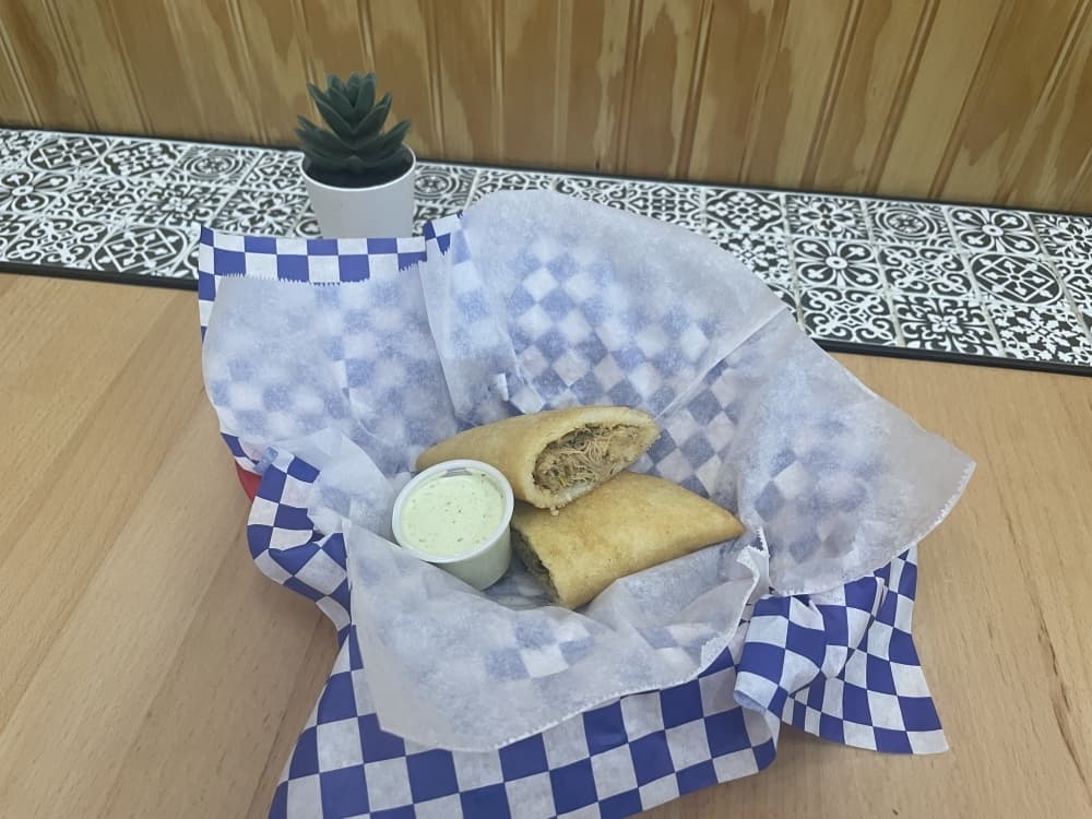 Empanada with shredded chicken ($5) is served with Aleida's sauce. (Eddie Harbour/Community Impact Newspaper)