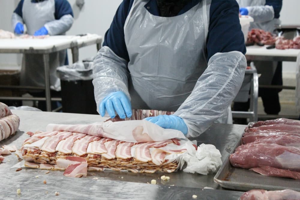 Employees package products to be sold commercially in grocery stores. (Emily Lincke/Community Impact Newspaper)